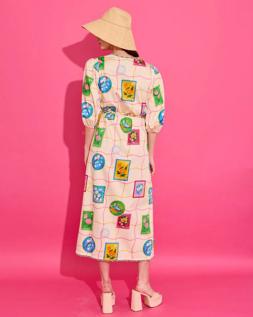 Alden Adair Lizzie Postcard Dress displayed on a hanger, featuring a vintage-inspired design with colorful floral print.