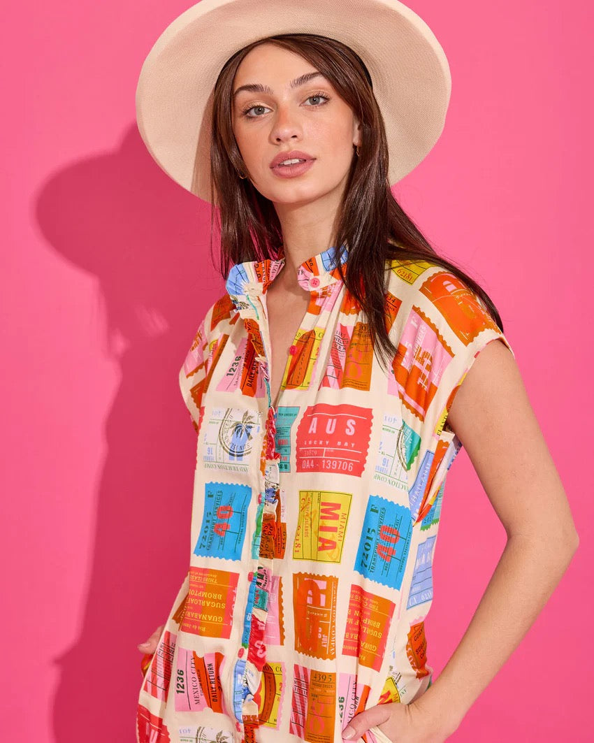 Alden Adair Margot Voyage Dress featuring a flowing fabric, floral pattern, and V-neck design, displayed on a hanger.