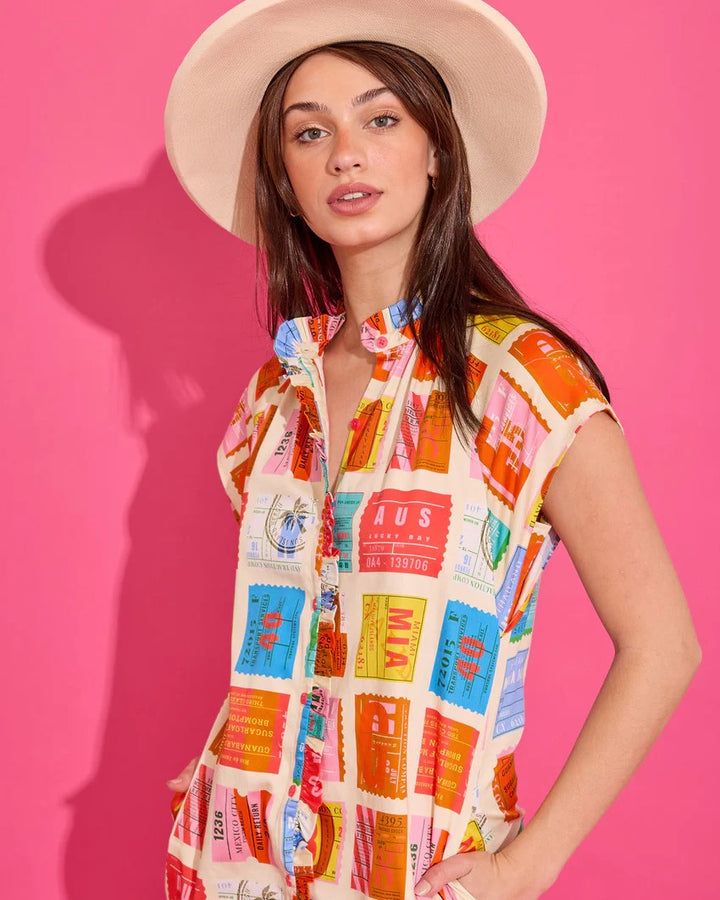 Alden Adair Margot Voyage Dress featuring a flowing fabric, floral pattern, and V-neck design, displayed on a hanger.