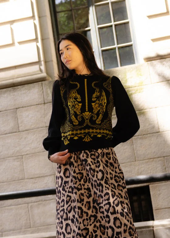 Alden Adair Lucie Panther sweater, a stylish long-sleeve top in black with a panther print design, displayed on a hanger.