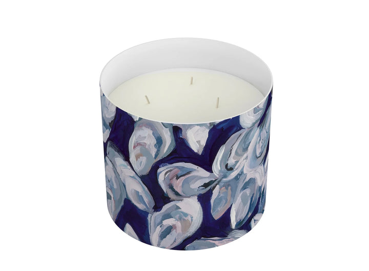 Annapolis Candle 3-wick home candle with lit wicks, in a clear glass jar with a white wax interior, ideal for home decor.