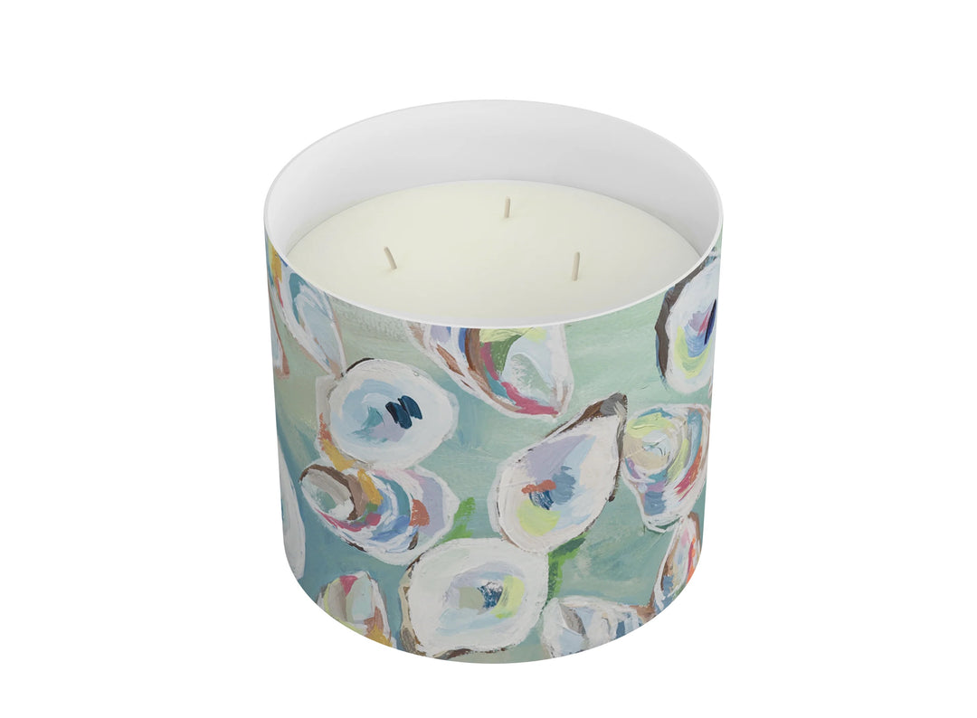 Annapolis Candle 3-wick home candle with a glass jar and white wax, candles lit, creating a cozy ambiance.