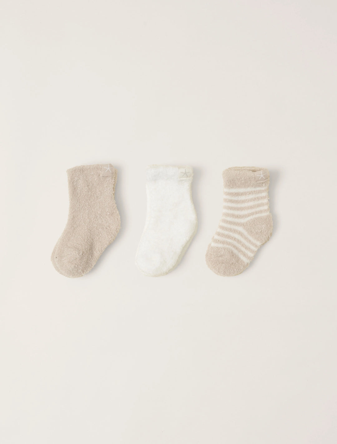 Soft barefoot dreams infant socks 3-pack with colorful patterns, perfect for gift-giving and keeping tiny feet warm.