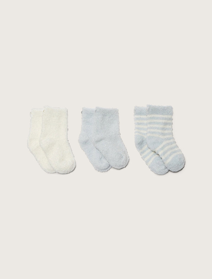 Set of three barefoot dreams infant socks in soft, colorful fabrics, perfect for gifting or keeping little feet cozy.