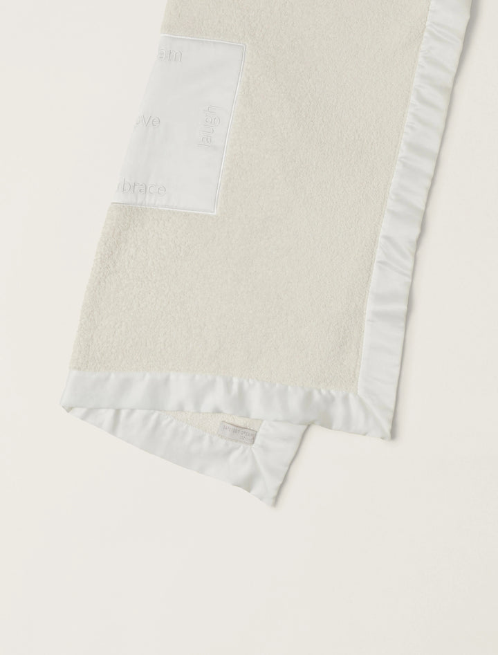 Barefoot Dreams satin trim receiving blanket with soft fabric and decorative satin edging, ideal for gifting or newborn comfort.