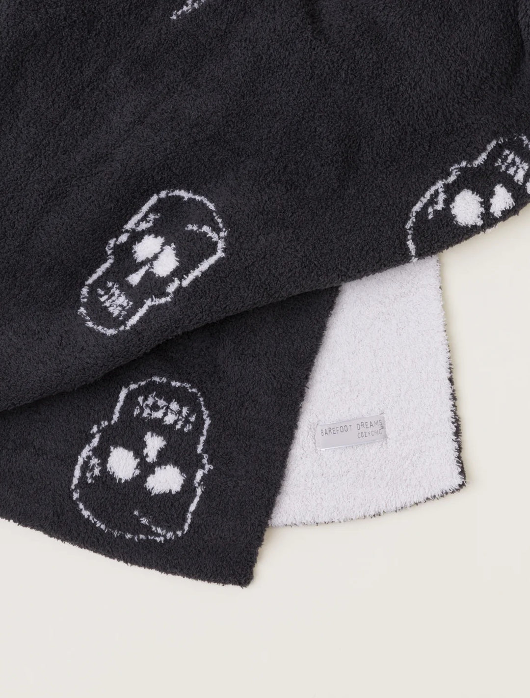 Barefoot Dreams Cozy Chic Skull throw blanket with soft knit texture, featuring a stylish skull pattern for home decor.