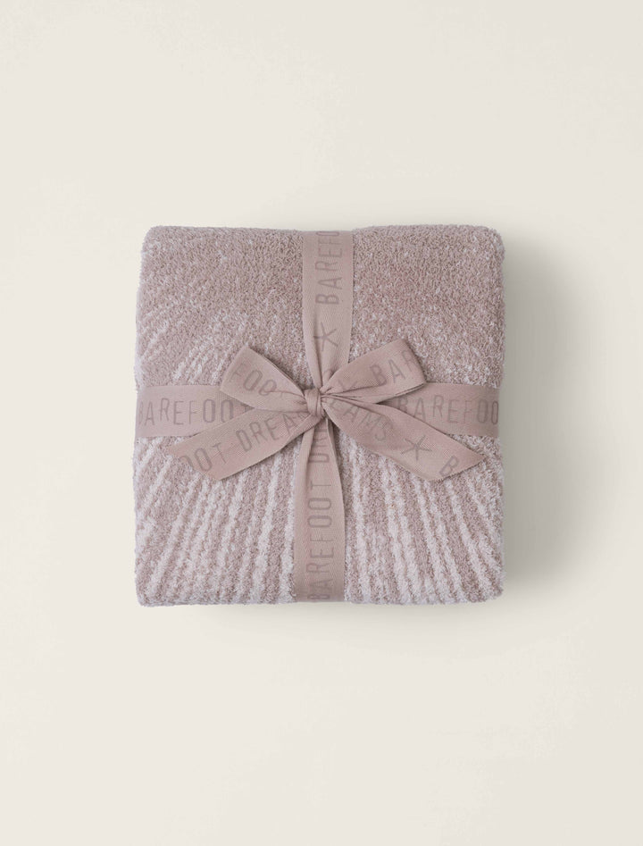 Barefoot Dreams Covered in Prayer blanket draped over a cozy home setting, showcasing soft, luxurious fabric and elegant design.