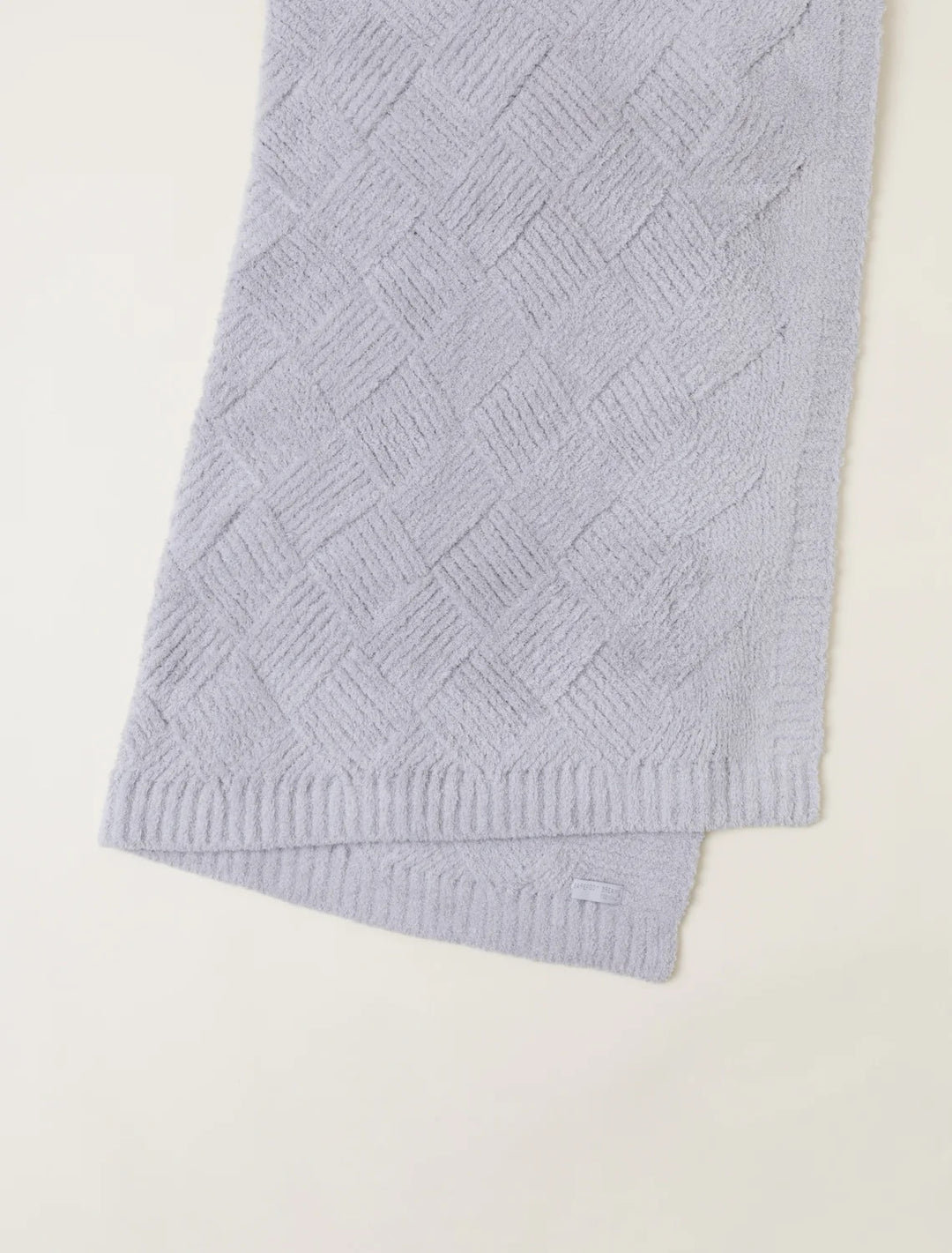 Barefoot Dreams diamond weave blanket showing soft, textured fabric with a diamond pattern in neutral tones for cozy home decor.