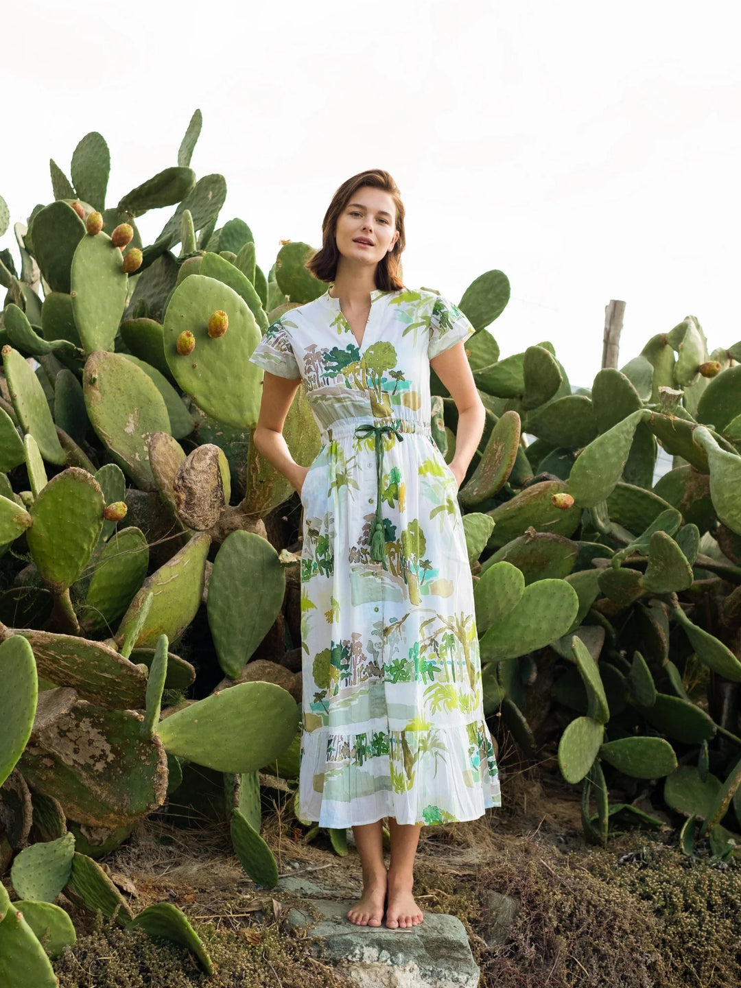 Beau & Ro palm flutter midi dress, lightweight fabric with tropical print, flowing silhouette, and short flutter sleeves.