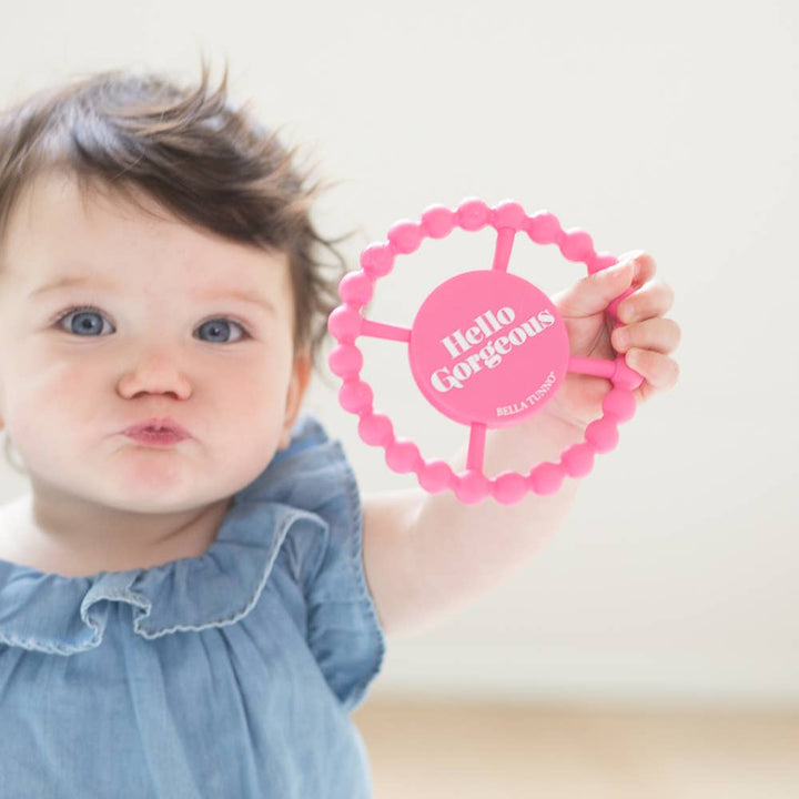 Bella Tunno Hello Gorgeous baby teether in soft pastel colors, featuring a smiling face design for soothing infants.