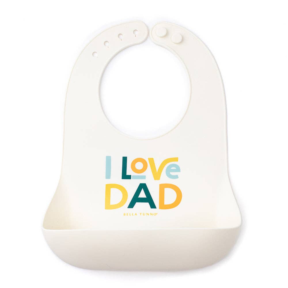 Baby wearing Bella Tunno I Love Dad Wonder Bib with colorful design, soft fabric, and adjustable neck closure.