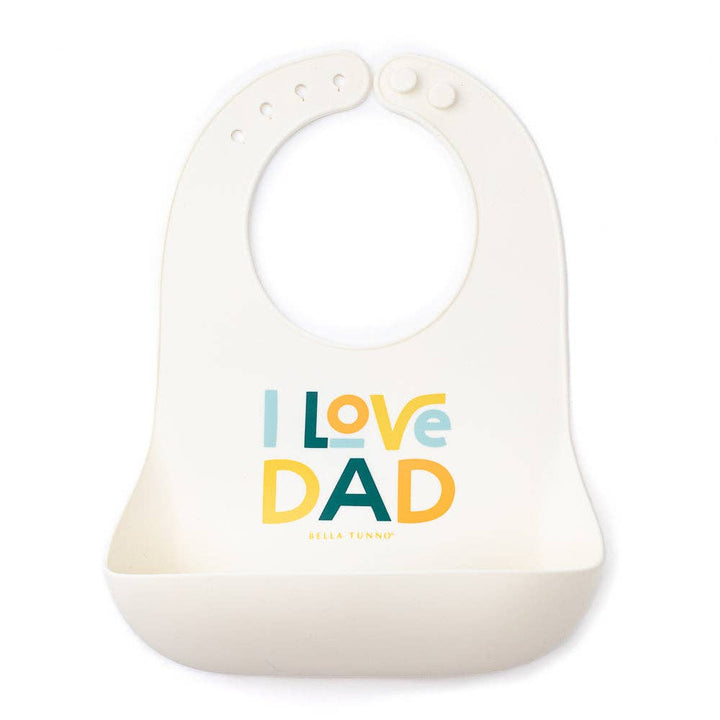 Baby wearing Bella Tunno I Love Dad Wonder Bib with colorful design, soft fabric, and adjustable neck closure.