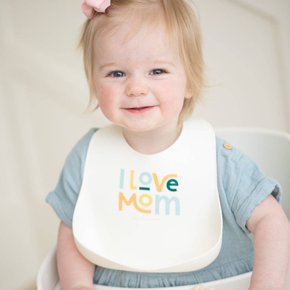 Bella Tunno I Love Mom Wonder Baby Bib with colorful design, soft fabric, and adjustable neck strap for comfortable feeding.