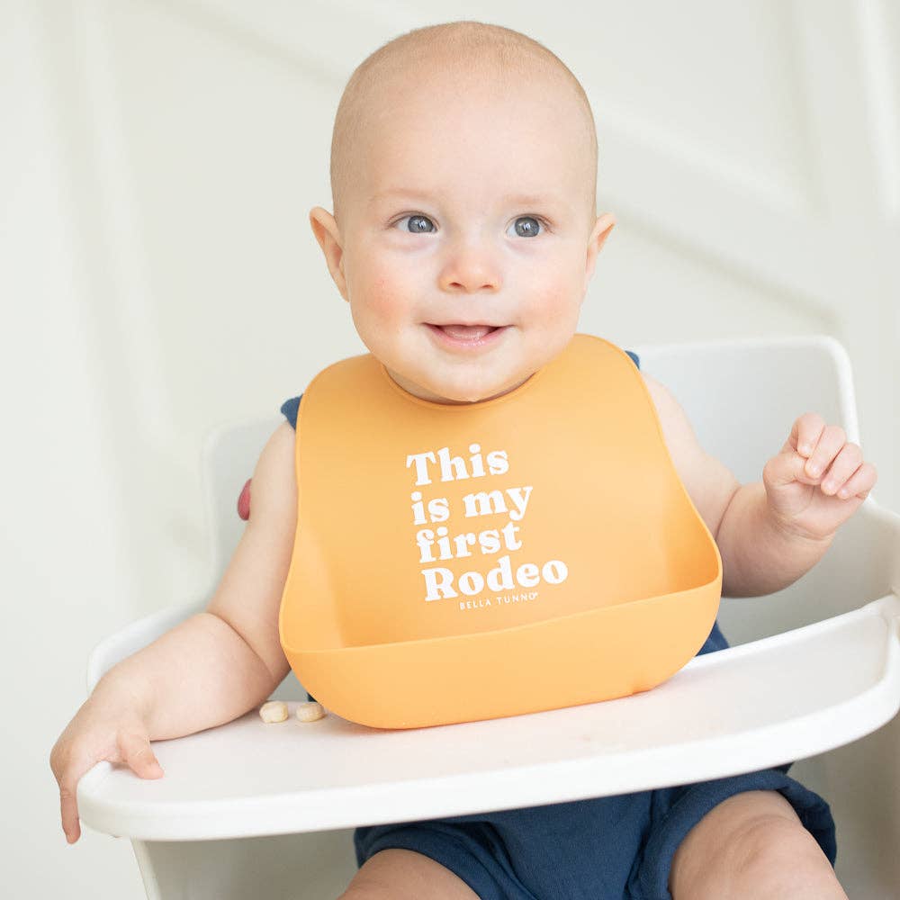 Bella Tunno First Rodeo Wonder Bib for babies, soft and colorful gift bib with playful design for feeding and teething.