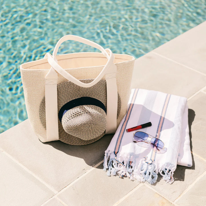 BFF Bags beach bag with colorful striped fabric, large open top, and sturdy handles, perfect for carrying essentials to the beach.