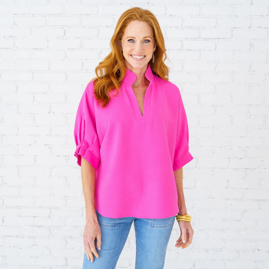 Caryn Lawn Caroline Top, stylish women's top in soft fabric with a relaxed fit and intricate detailing, displayed on a hanger.