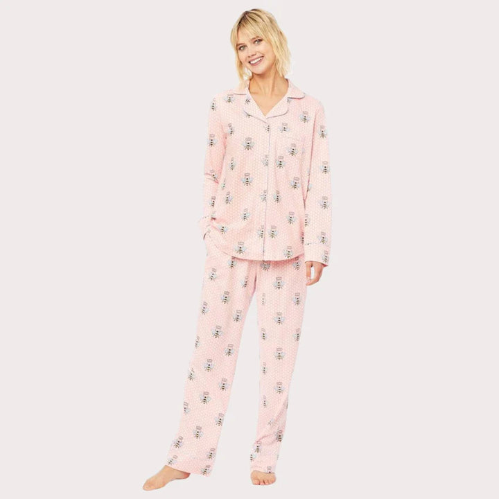 Pink Queen Bee Pima pajamas by Cat's Pajamas, featuring soft fabric and bee-themed design, displayed as accessories in the image.