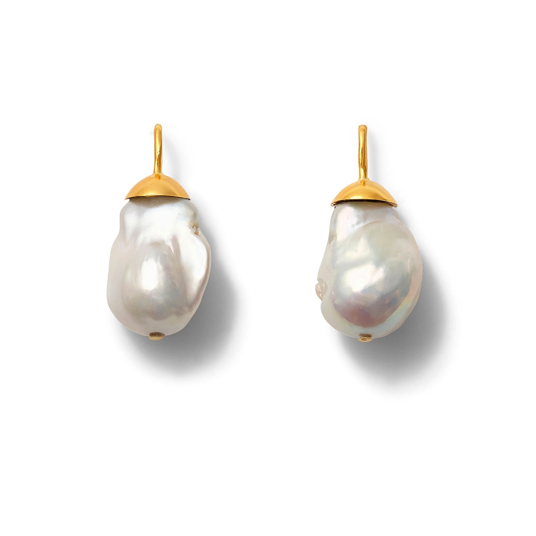 Big Baroque pearl earring from Catherine Canino featuring a large, irregularly shaped pearl with silver hook detail.