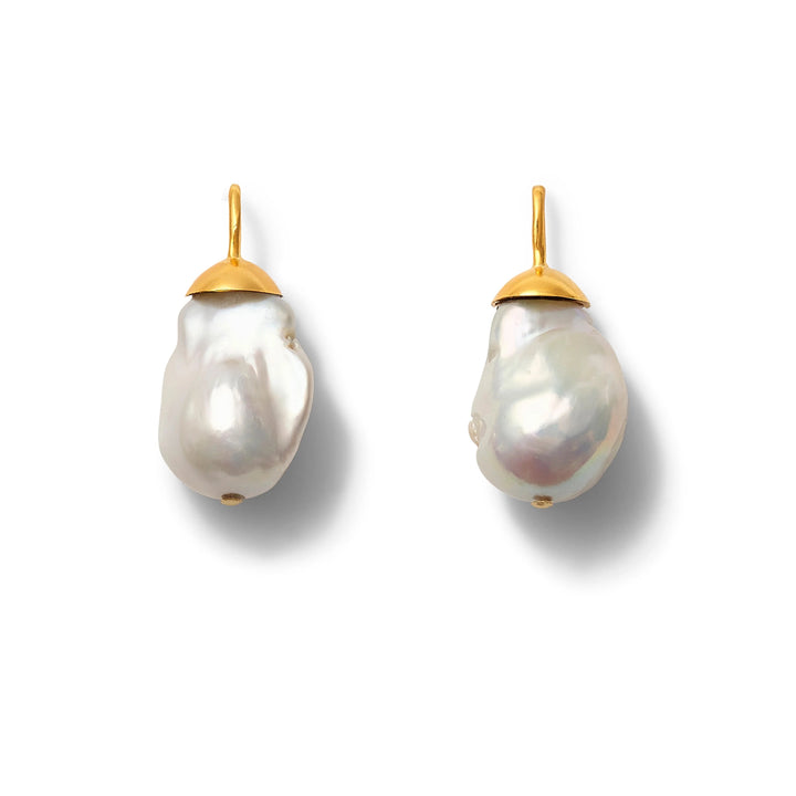 Big Baroque pearl earring from Catherine Canino featuring a large, irregularly shaped pearl with silver hook detail.