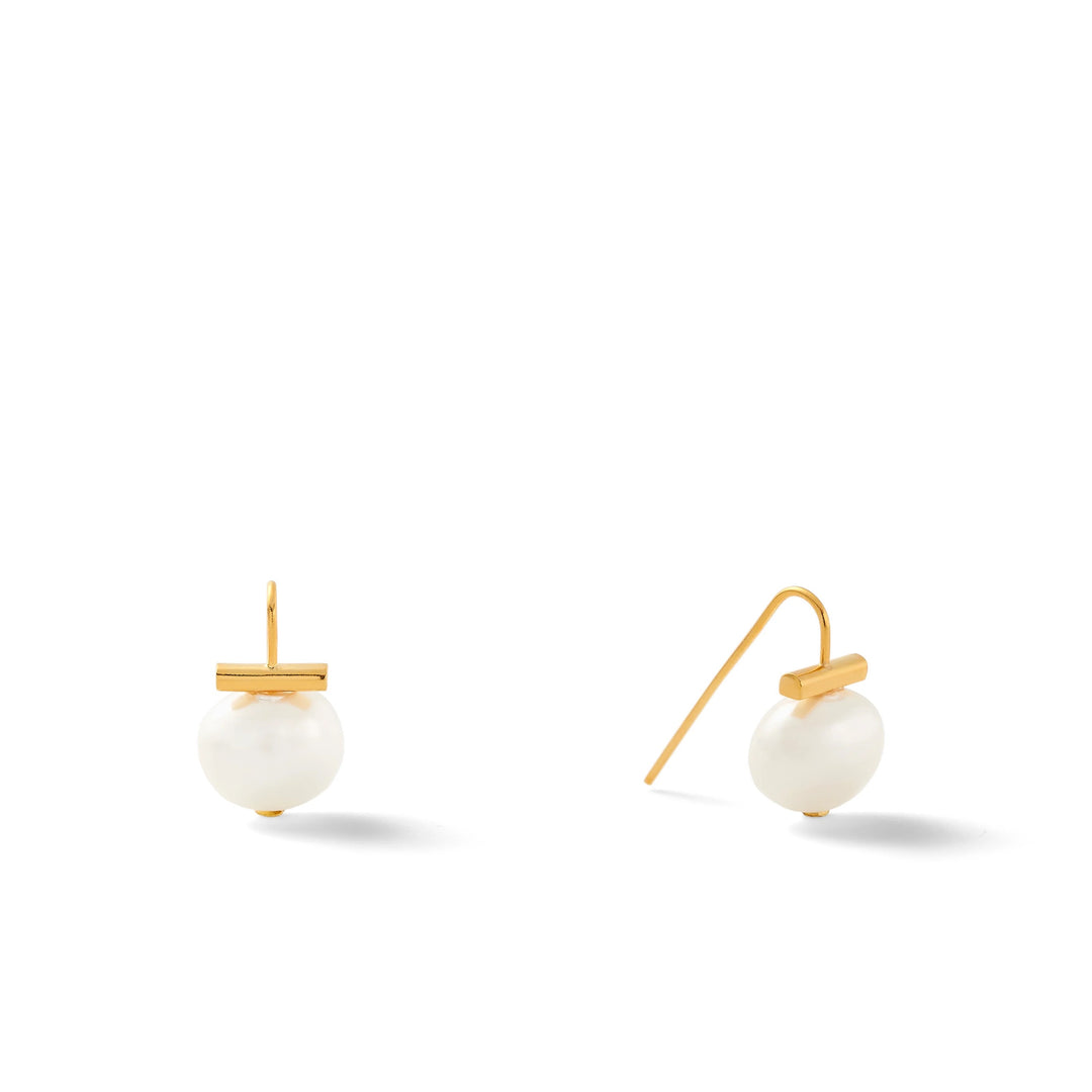 Pearl Petite Pebble earring by Catherine Canino featuring a small, smooth pearl-shaped accessory in a natural, elegant design.