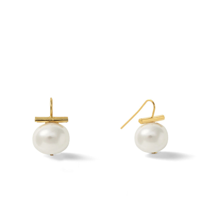 Catherine Canino Pebble Medium Pearl Earring featuring a smooth, round pearl on a delicate accessory setting.