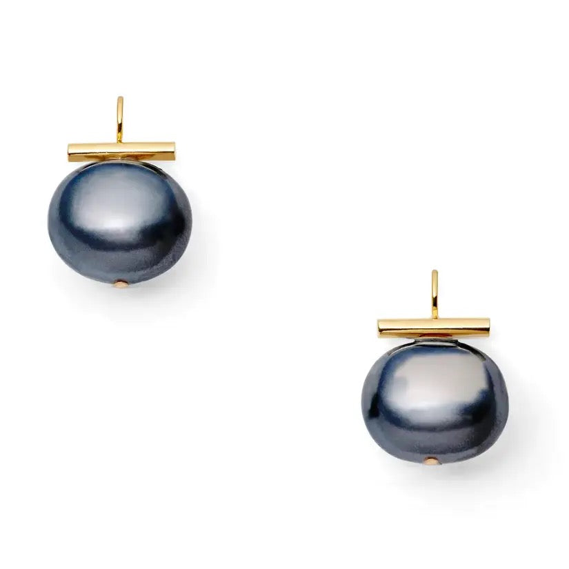 Catherine Canino Pebble Medium Pearl Earring showing a round pearl hanging from a delicate gold hook.