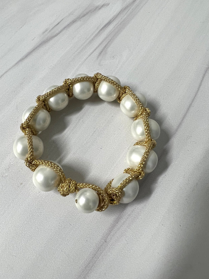 Pearl macrame bracelet with button clasp by Catherine Canino, featuring intricate knotting and elegant pearl accents.