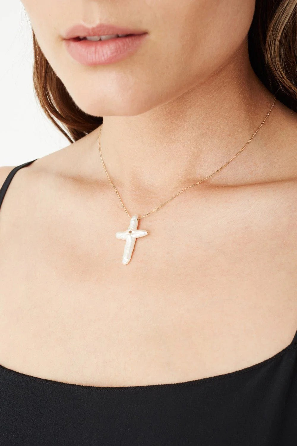 Chan Luu pearl cross with diamond necklace, elegant jewelry accessory featuring a pearl cross pendant and sparkling diamonds.