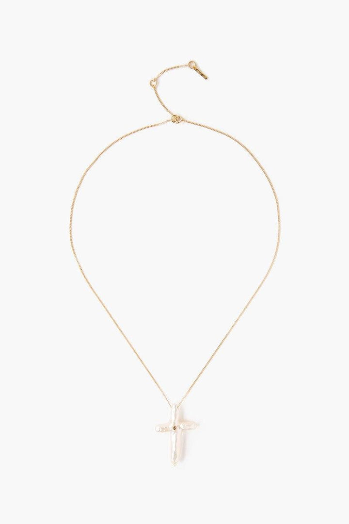 Chan Luu pearl cross with diamond necklace, elegant accessories featuring a baroque pearl cross and sparkling diamond accents.