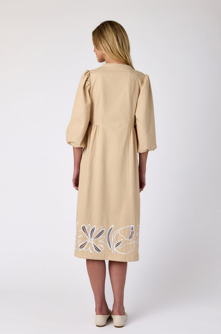 Crosby by Mollie Burch Indie dress featuring a flowing silhouette, floral pattern, and long sleeves, displayed on a hanger.