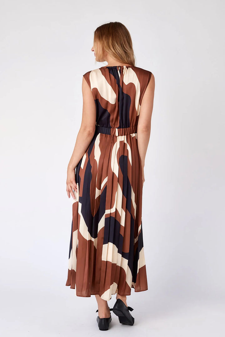 Crosby by Mollie Burch The Brantley dress in a stylish, flowy design with floral pattern and sleeveless cut displayed on a hanger.