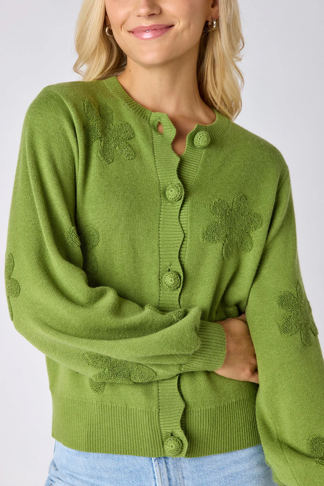 Crosby by Mollie Burch Colson Grass Cardigan, a stylish knit top with a textured green pattern, displayed on a hanger.