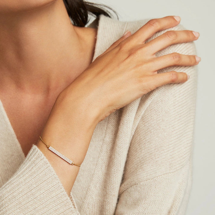 DeaN Davidson Signature Pave Bar Chain Bracelet, close-up of sleek gold-tone jewelry with pave accents on a white background.