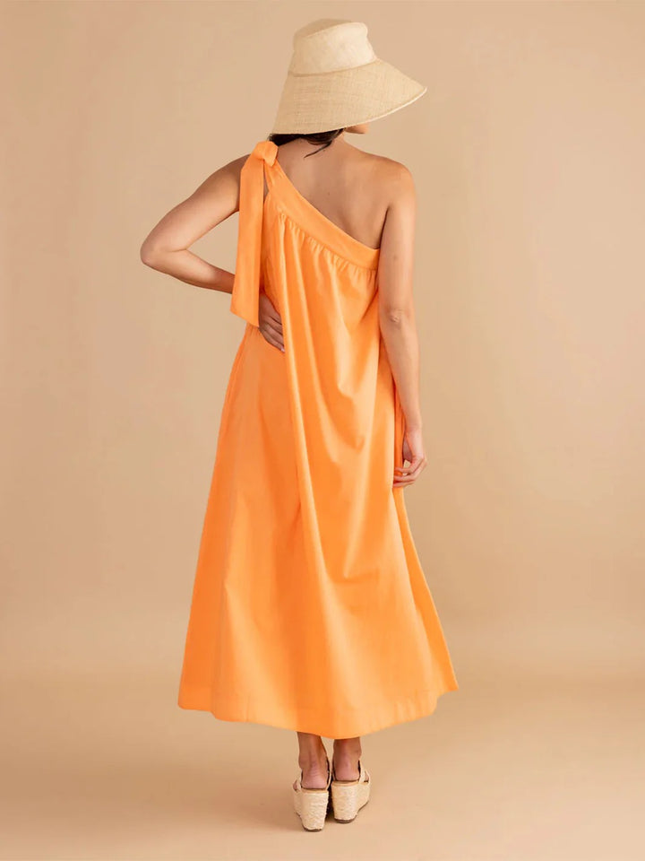 Double A Juliette Dress in vibrant melon color, featuring a stylish sleeveless design and flowing fabric.