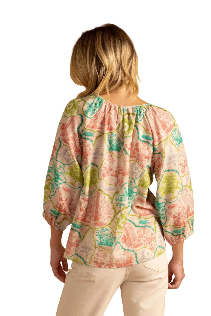 Double A Beatrice Tea Party Blouse, stylish women's top with floral details and ruffled sleeves, displayed on a hanger.