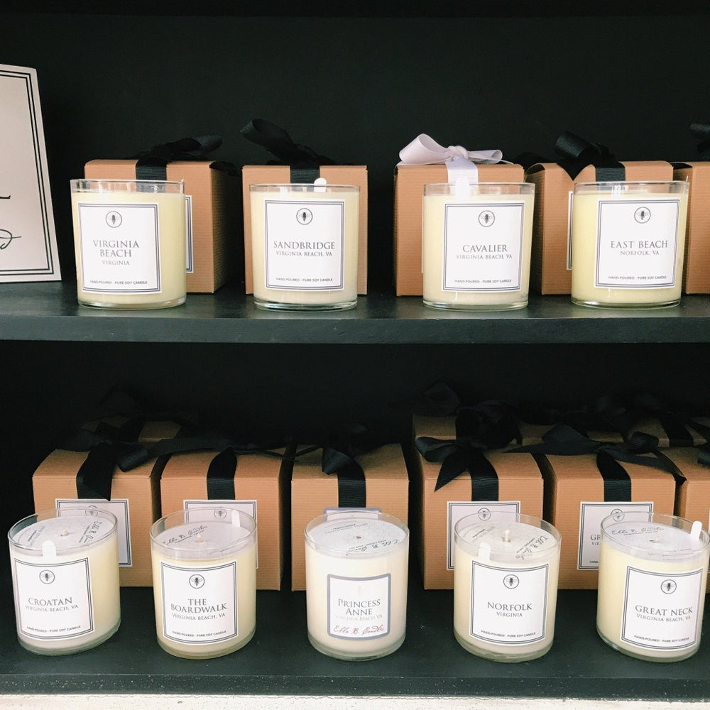 Ella B. Candles neighborhood candles in a decorative glass holder, featuring warm, inviting candlelight and elegant design.