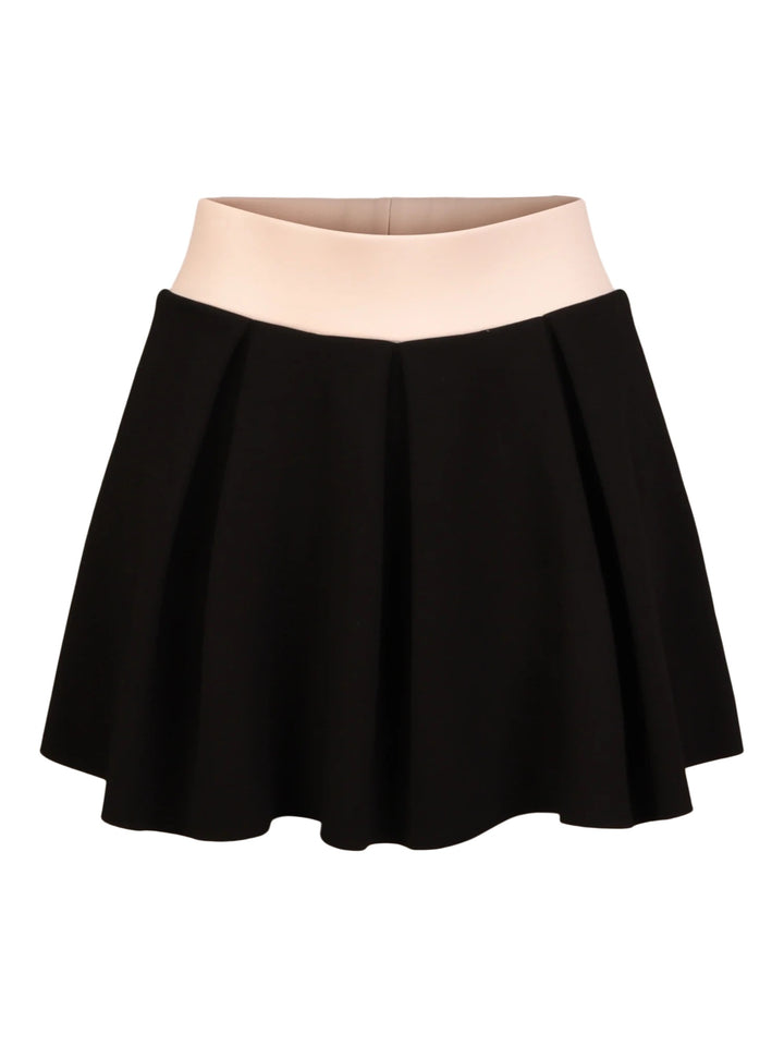 Emily McCarthy Sydney skirt, stylish women's bottoms in a vibrant design, shown on a hanger with a blurred background.