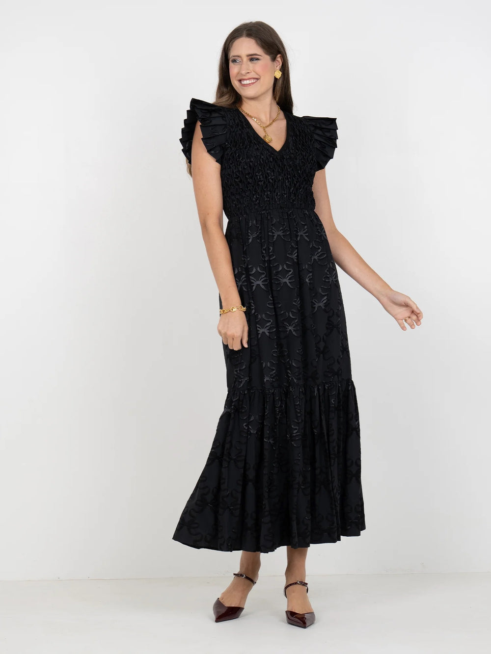 Emily McCarthy Grace Bow Lattice Midi Dress showing a feminine dress with bow details and lattice pattern, knee-length style.