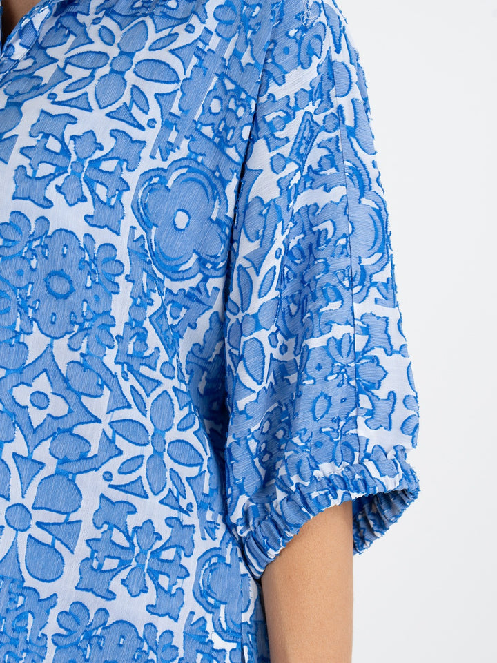 Emily McCarthy Bonny Positano Top, stylish women's top with colorful floral pattern and lightweight fabric.
