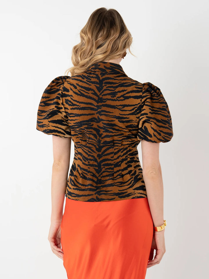 Emily McCarthy Britt Cheeky Cheetah Top, stylish cheetah print blouse with a relaxed fit and short sleeves.
