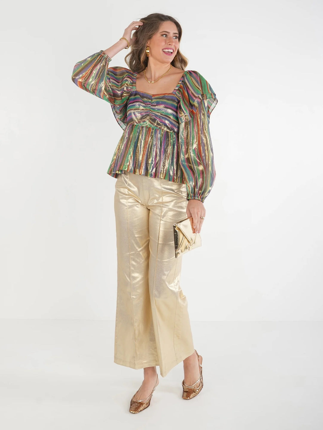 Emily McCarthy Gigi Top, stylish women's blouse with intricate detailing and soft fabric, shown on a hanger.