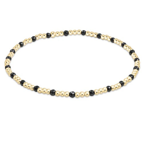 Enewton gemstone gold sincerity pattern 3mm bead bracelet with multicolored beads on a stretch cord, close-up shot.