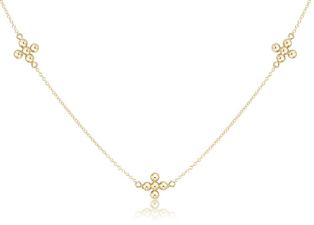 Enewton 17-inch gold choker necklace with beaded chain and signature cross pendant, stylish jewelry accessory.