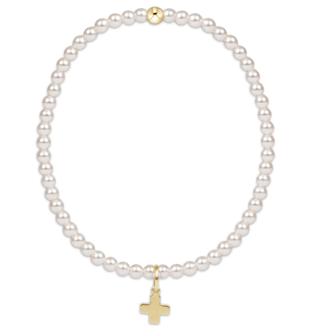 Enewton classic pearl 3mm bead bracelet featuring a signature cross gold charm, elegant accessory with white pearl beads.