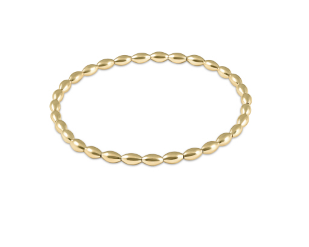 Small gold bracelet by Enewton, featuring a delicate design, shown on a neutral background. Perfect for elegant accessories.