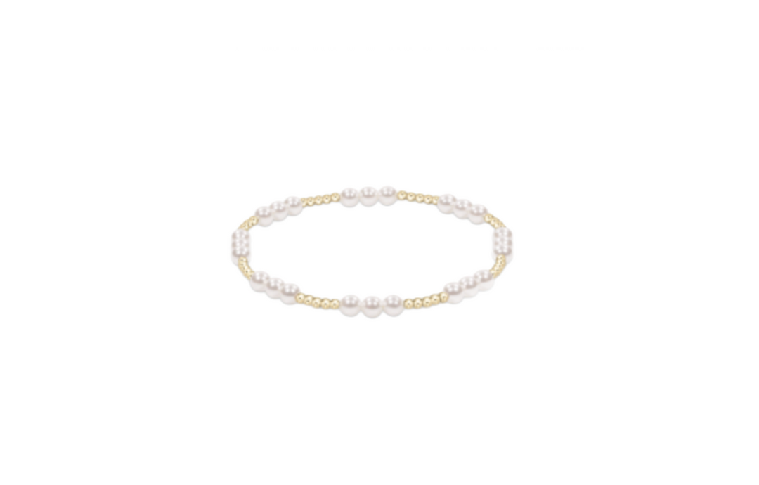 Enewton Joy Pearl 4mm bracelet featuring white pearls and a delicate clasp, styled as a jewelry accessory on a neutral background.