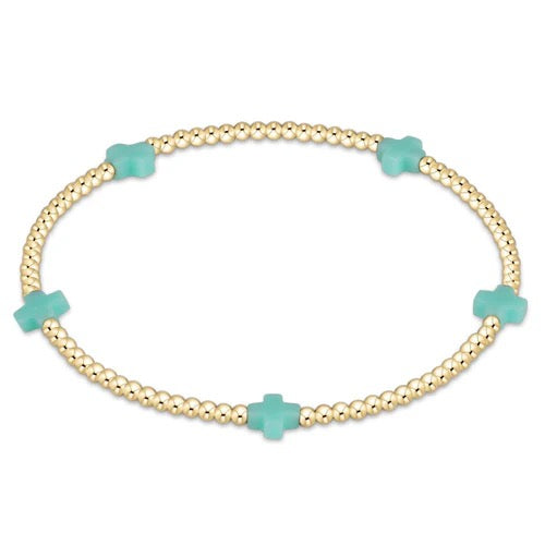 Enewton Signature Cross Small 2MM Gold Bracelet, close-up of the delicate gold chain with a small cross charm.