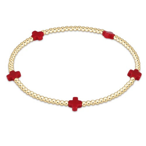 Enewton Signature Cross Small 2MM gold bracelet, close-up of delicate accessory with cross charm, on a white background.