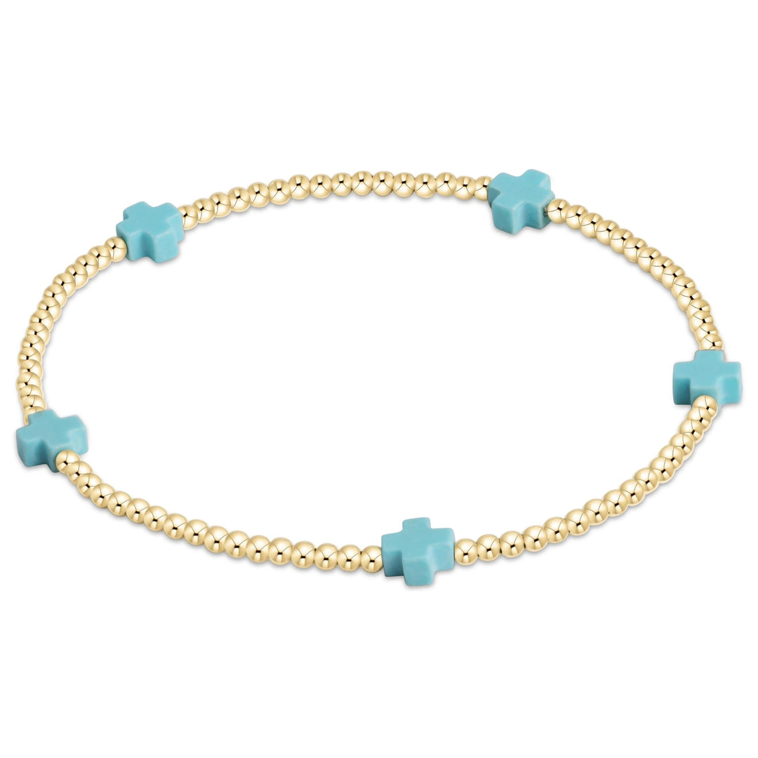 Enewton Signature Cross Small 2MM gold bracelet, a stylish accessories piece with a delicate cross charm on a thin gold chain.