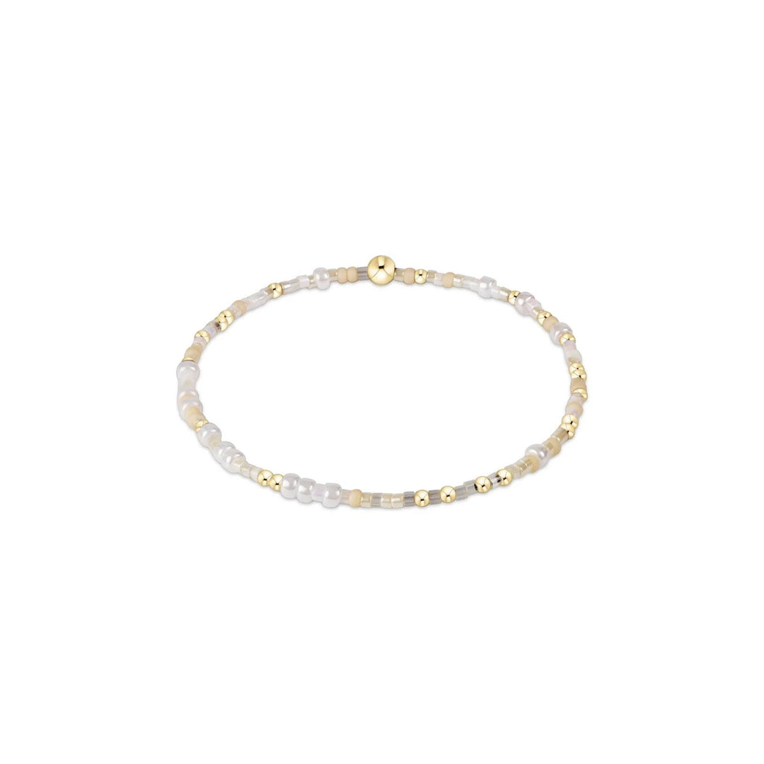 Enewton Hope Unwritten bracelet with silver-tone chain and engraved charm, laid flat on a neutral background.